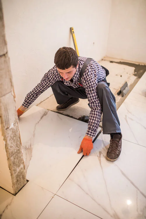 construction worker working on expanding bathroom