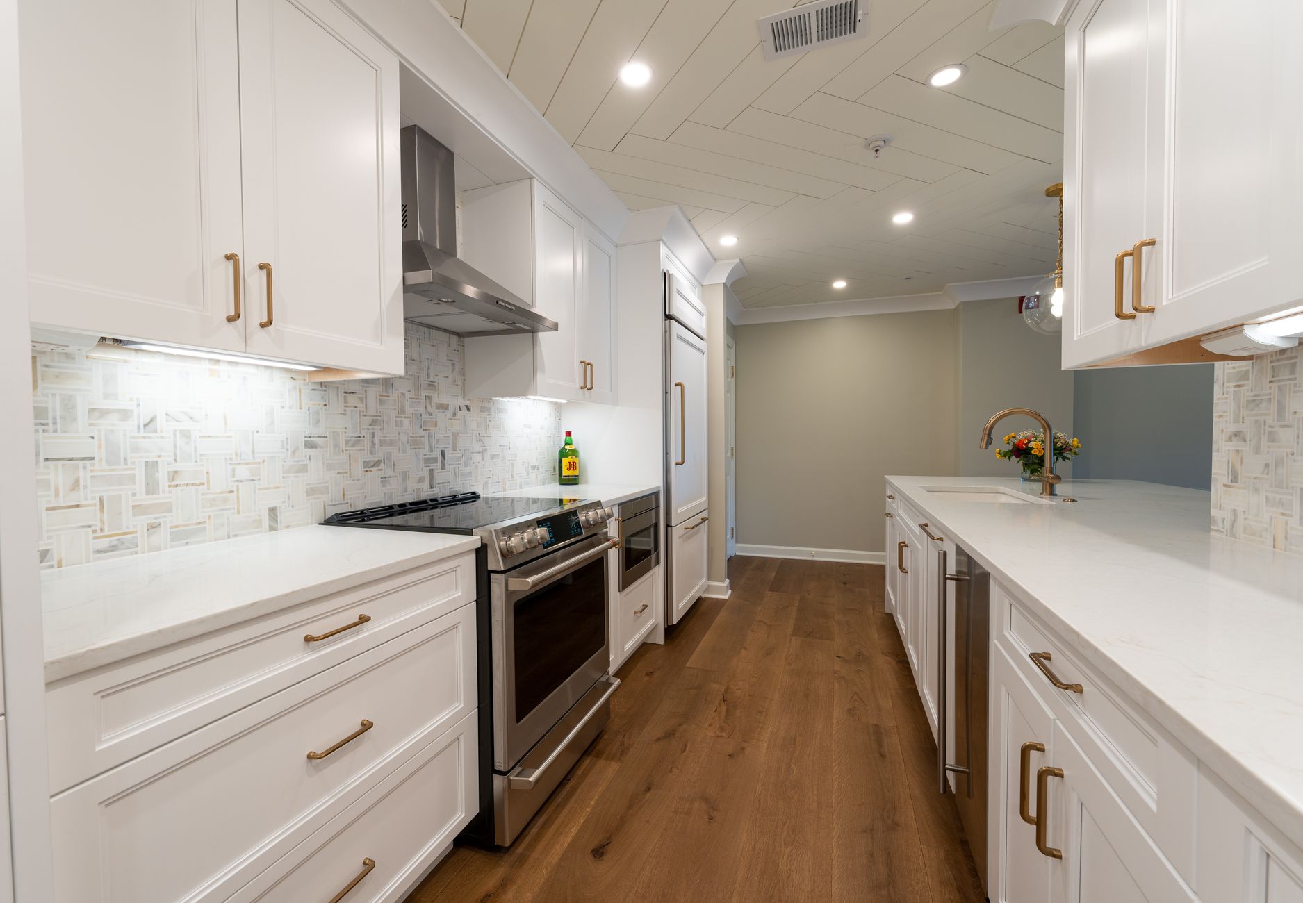 A split-screen interior photo showing a modern renovated bathroom with white quartz countertops and glass shower on the left